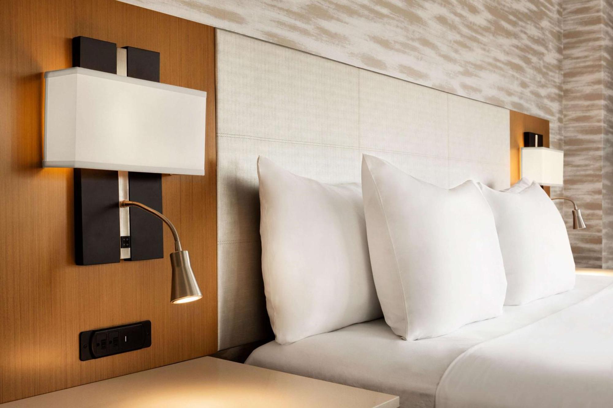 Radisson Hyderabad Hitec City Экстерьер фото A bed with a headboard